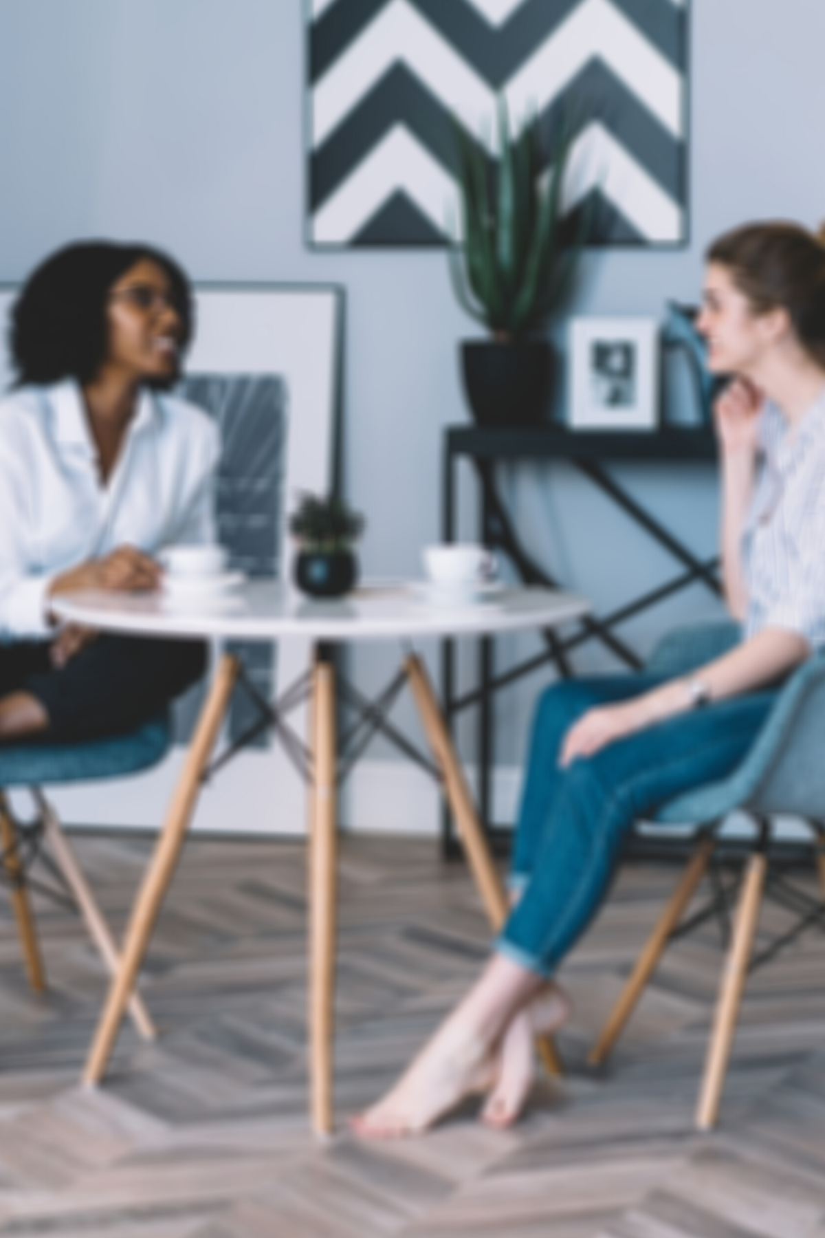 two women having a conversation over coffee at at table