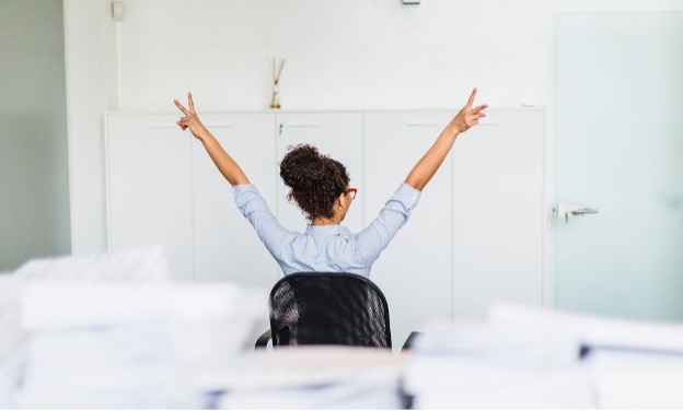 professional woman sitting facing the wall with peace fingers